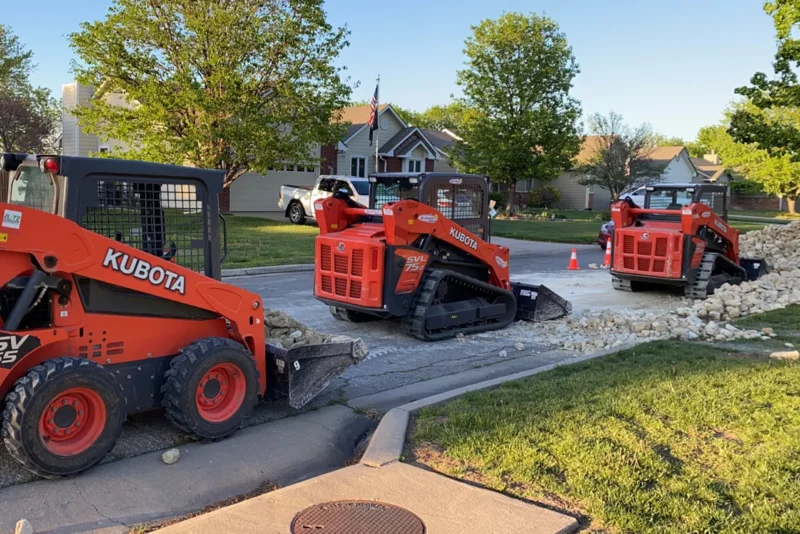 Skid Steers Add Rock To Neighborhood Lake